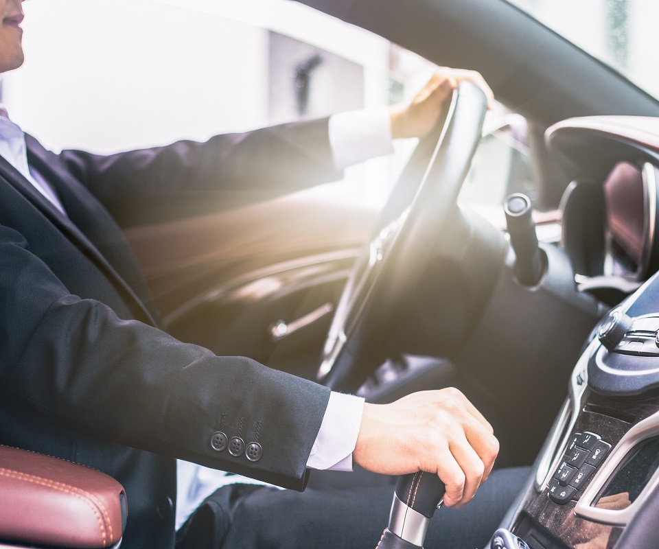 detail shot of young businessman driving his car.